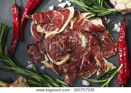 Hamon.tasty Ham Sliced ​​into Strips On A Wooden Background With Spices And Fresh Thyme. A Serving O