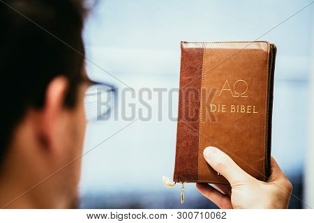 Christian Preacher: Young Man Is Holding The Bible, Praying
