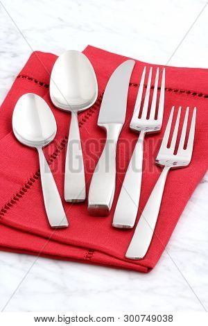 Trendy And Beautiful Silverware Set Styled On Linen Double Hemstitch Napkin And Antique Carrara Marb