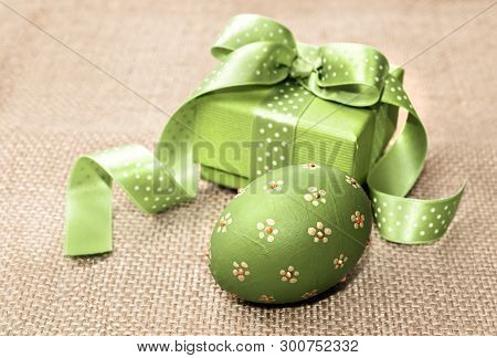 Green Easter Egg And Gift Box On Sackcloth. Happy Easter!