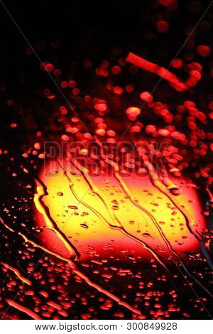 Traffic Is Viewed Through The Car's Windshield Covered In Rain, . Beautiful Background Of Rain And L
