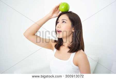 Healthy Diet And Nutrition. Protrait Of A Beautiful Asian Woman Relaxing Sitting On Sofa Holding A G