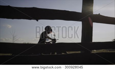 Motorcyclist Pulls A Broken Bike. Motorcyclist Rolls His Motorcycle. Motorcyclist Goes Near His Bike