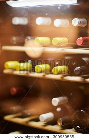 Wine Bottles Cooling In Refrigerator. Close Up.
