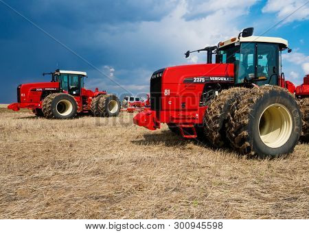 DECABRIST VILLAGE, SARATOV REGION, RUSSIA - 28 APRIL 2019: Sowing works on the wheat field. Planting complex - tractor and seeder mechanism
