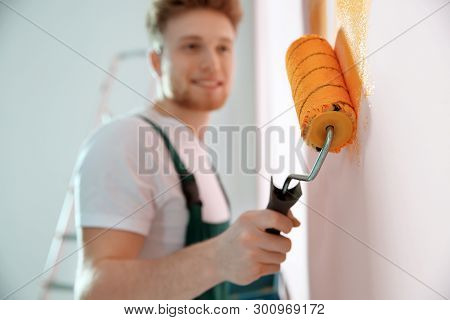 Professional Decorator Painting Wall Indoors. Home Repair Service
