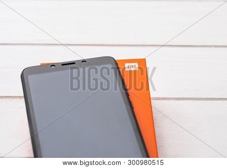 Kharkiv, Ukraine - 02 Fabruary 2019: New Xiaomi Redmi 6 smartpphone on a wooden table