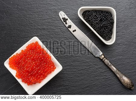 Grainy Caviar Of Paddlefish Fish In A White Ceramic Plate And Red Chum Salmon Caviar In A White Cera
