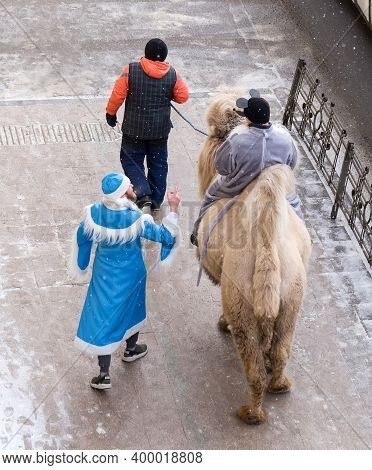 Irkutsk, Russia- 23 December 2019: Man In Mouse Rides Camel On Lenin Street