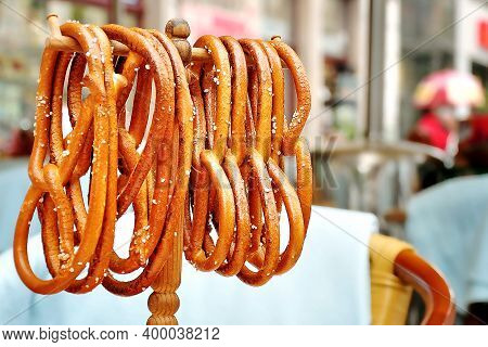 Traditional Czech Pretzels Hang On A Stand On The Table. Waiting For Guests, Tables Were Prepared To