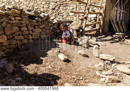 Jhong, Nepal - November 17, 2015: Little Nepali Child Playing On The Ground.