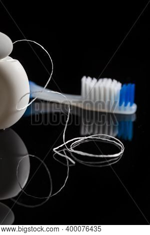 Dental Care Concepts. Two Professional Electric Toothbrushes In Front Of Four Manual Tooth Brushes O