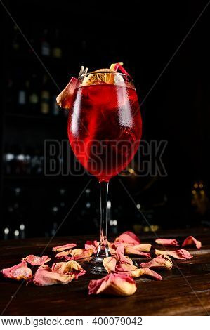 Golden Orange And Rum Cocktail Aperol Sprizz Served In Long Stemmed Glasses On An Old Wooden Counter
