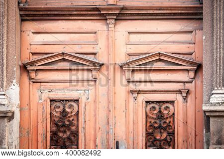 Detail Of An Old Vintage Orange Wooden Door On The Front Entrance Of A Residential Building In Vojvo