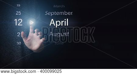 April 12nd. Day 12 Of Month, Calendar Date. Hand Click Luminous Icon Play And Date On Dark Blue Back