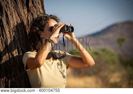 Close-up Of Brunette By Tree Using Binoculars