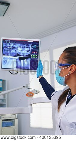 Dentist Doctor And Patient Looking At Digital Teeh X-ray In Dental Office, Person Pov. Stomatology W