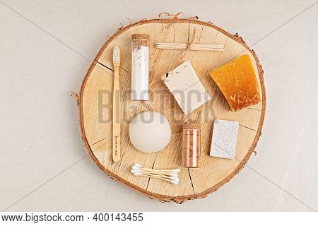 Eco Friendly Soap Bar, Tooth Brushes, Cotton Swabs, Bath Salt, Clay Mask And Washcloth On Neutral Ba