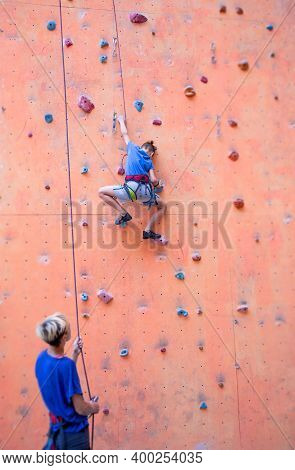 A Boy Climbs The Wall, A Coach Teaches A Child