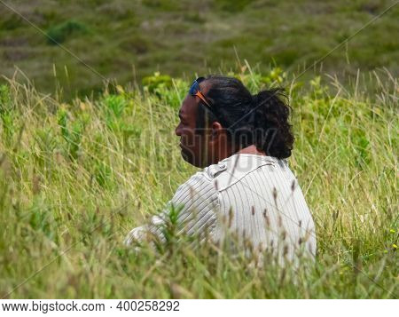 Angaroa, Easter Island, Chile - December 20, 2018: An Indigenous Resident Of Easter Island Sits In T
