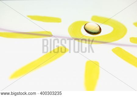 Vitamin D And E Capsule Lies Inside Drawn Sun. The Benefits Of Vitamins For The Body Concept
