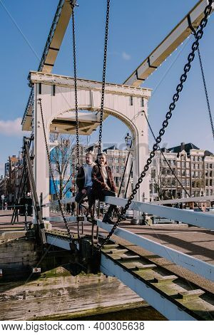 Couple Men And Woman On City Trip At Amsterdam Historical Centre Amsterdam Holland Netherlands. Dutc