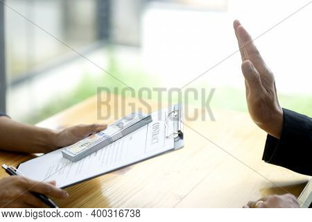 Officer Hand Refusing To Take Bribe Cash Banknote From Businessman In The Concept Corruption