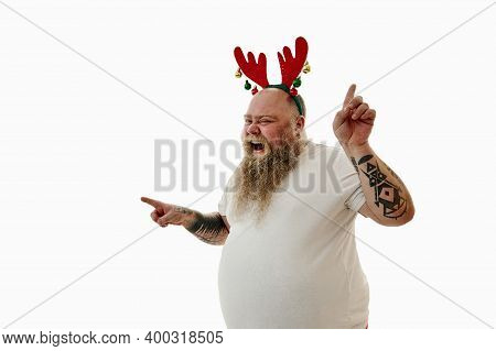 Portrait Of An Overweigh Man With Tattooed Arms Wearing A Hoop With Antlers On The Head Expressing H