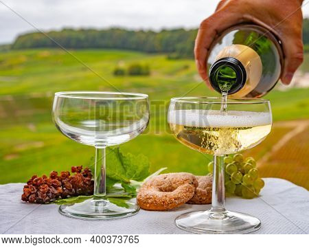 Tasting Of French Sparkling White Wine With Bubbles Champagne On Outdoor Terrace With View On Grand