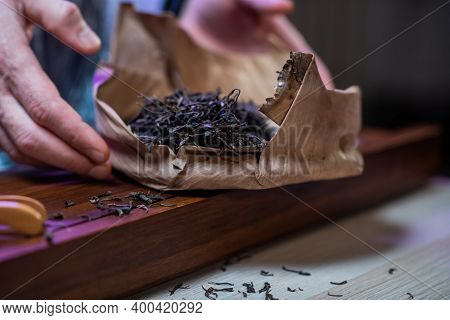 Dry Leaves Of Fragrant Ripe Tea Are Laid Out Next To The Gongfu Bamboo Tray In The Tea Shop. Close-u