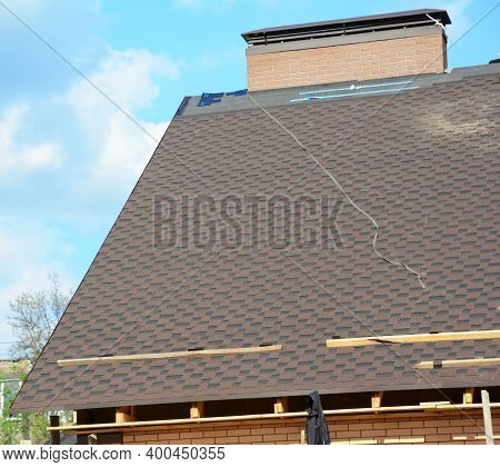 A View On An Incomplete Roof With Asphalt Shingles Installation On The Waterproof Underlayment. Asph