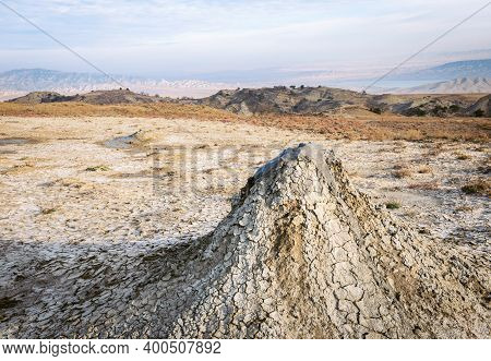 Close Up Of Natural Mud- Volcanoe In Chachuna Manged Reserve With Beautiful Panorama Of Mountains