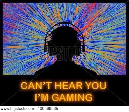 A Video Game Player In Headphones Sits In Front Of A Bright Video Screen. Neon Lights Spell The Word