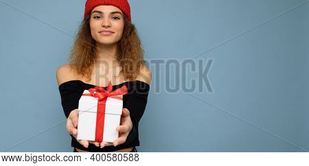 Shot Of Beautiful Positive Smiling Young Dark Blonde Curly Woman Isolated Over Blue Background Wall 