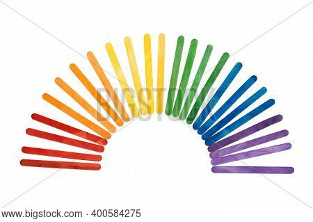 Rainbow Color Wooden Ice Cream Sticks On White. Colorful Abstract Arch
