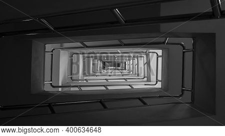Abstract Perspective Rectangle Pattern From Bottom View Of Moody Stairwell Inside Of Building In Bla