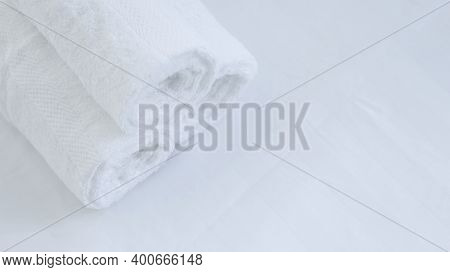 Close Up Oftowel Placed On Basket, White Table Top, Bottle Of Liquid Soap, Spa Set For Bathing In Th