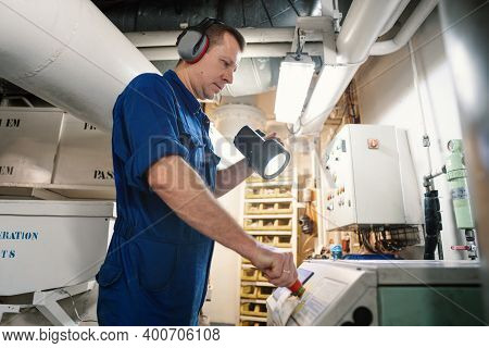 Marine Engineer Officer Controlling Vessel Enginesand Propulsion In Engine Control Room Ecr