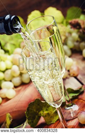 Champagne Pour In Glass, Grapes With Vine, Vintage Wood Background, Selective Focus