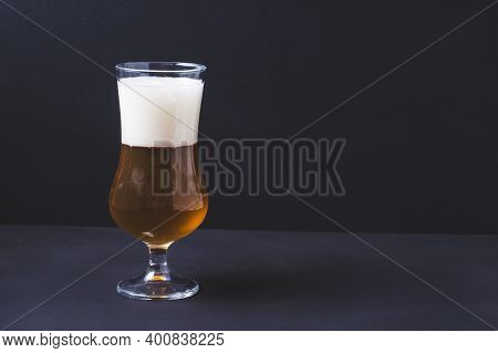 Beer Glass Tulip With Homemade Beer And Foam On Black Background.craft Beer Brewing From Grain Barle