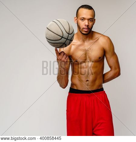Muscular African American Sportsman Playing Basketball Shitless Over Light Grey Background