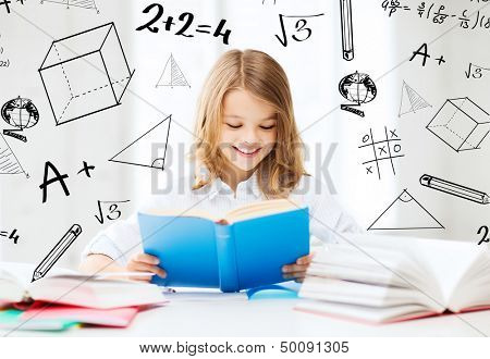 education and school concept - little student girl studying and reading books at school