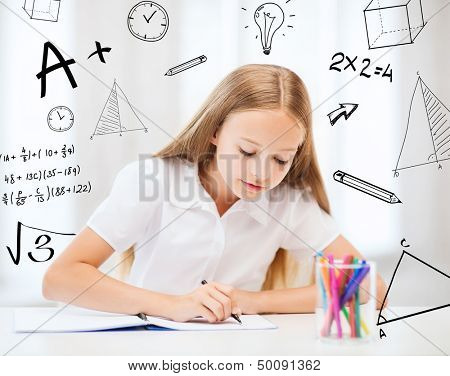 education and school concept - little student girl drawing at school