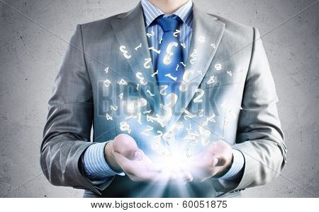 Close of businessman holding numerals in palms