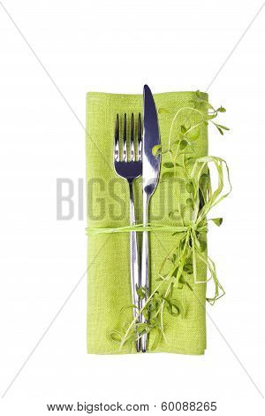 Knife And Fork With Green Linen Napkin Isolated On White