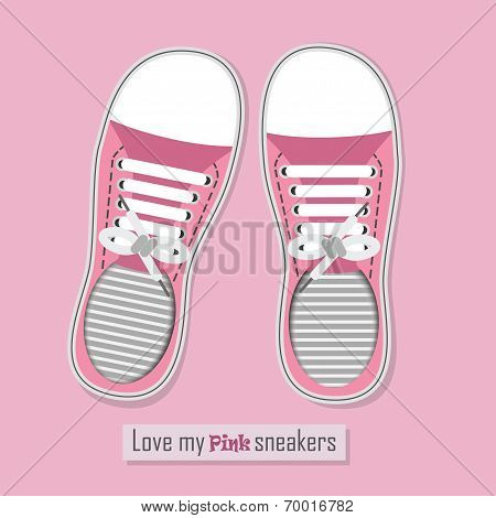 A pair of pink sneakers on pink background