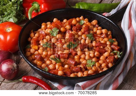 Chickpeas With Chorizo In A Frying Pan And The Ingredients