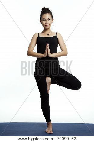 Young Beautiful Yoga Posing On A White Studio Background.