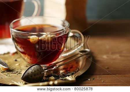 Beautiful vintage composition with herbal tea, on wooden table