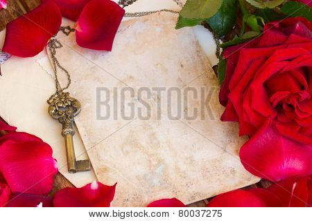 vintage background with rose petals and key